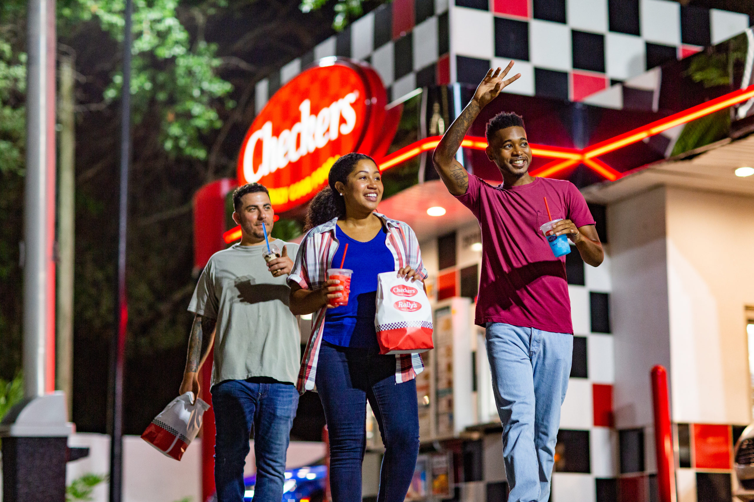 Guests Smiling in front of Checkers Restaurant