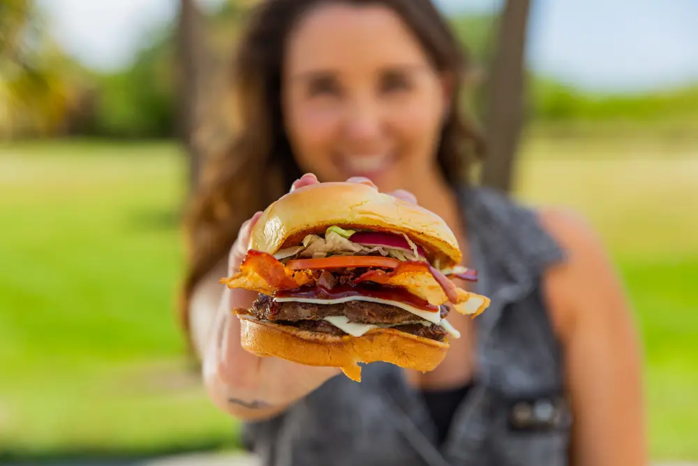 Woman holding a Checkers cheeseburger